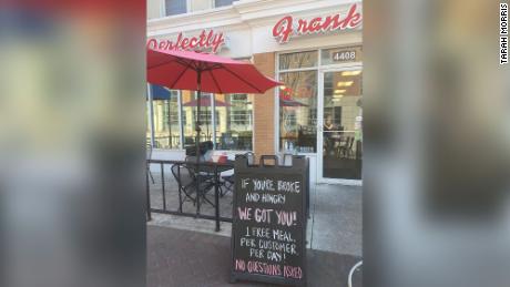 A sign outside of Perfectly Frank invites customers for a free meal.