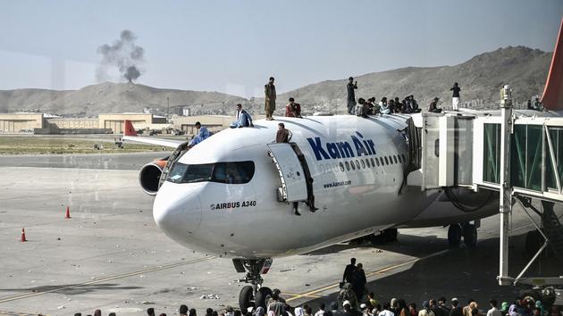 On the runway of Kabul Airport, scenes of chaos and despair