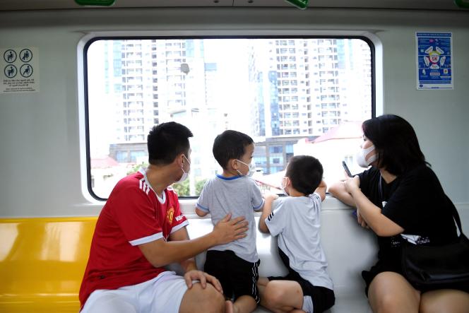 A family navigates the city's first urban metro along the Cat Linh-Ha Dong Line in Hanoi on November 6, 2021.