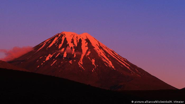 Snow-covered Mount Ngauruhoe, lit up red at sunrise
