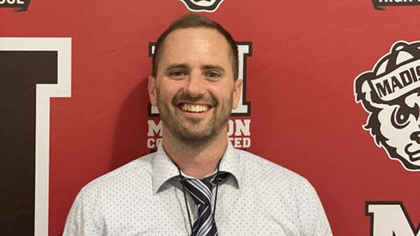 Adam Dennis was introduced as the head coach of Madison's women's basketball