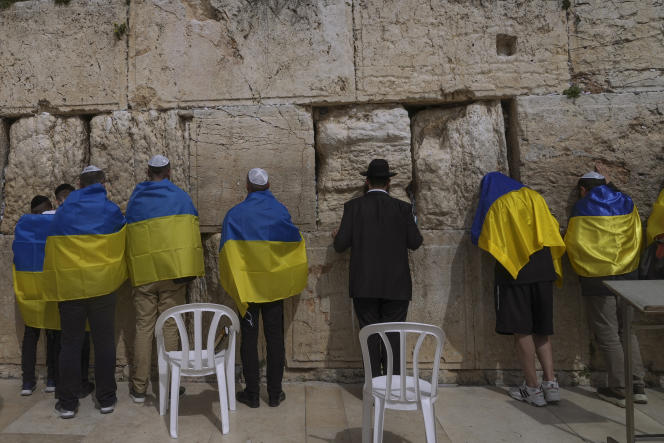 A Ukrainian delegation decorated in the colors of the national flag prays outside the Western Wall in Jerusalem on April 1, 2022.