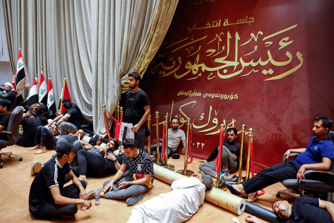 Supporters of Shiite leader Muqtada al-Sadr take a rest during an anti-corruption demonstration inside the Iraqi parliament building in Baghdad on July 30, 2022.