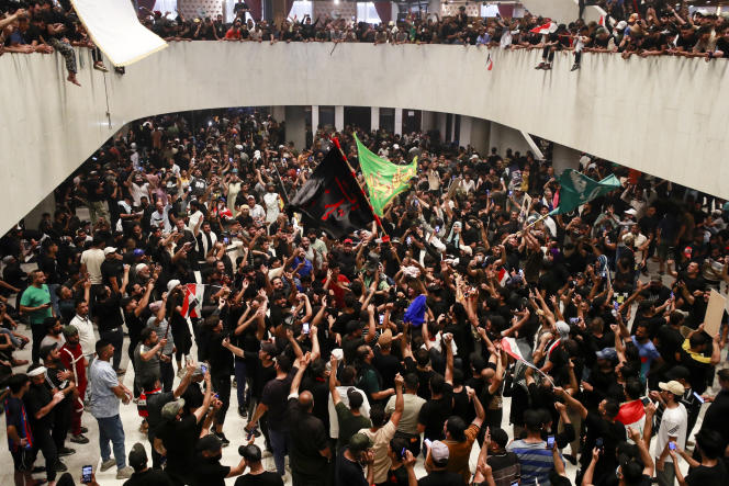 Supporters of Muqtada al-Sadr cheer as they enter the Iraqi parliament, located in the heavily-guarded Green Zone in the capital, Baghdad, on July 30, 2022. 