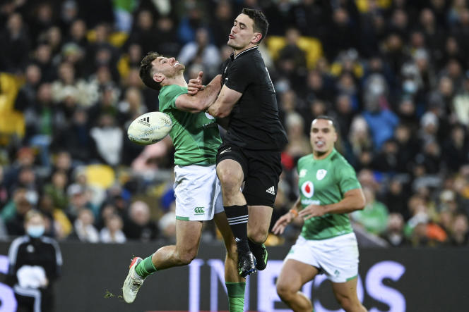 New Zealander Will Jordan hits an Irish player during the match between the two selections, in Wellington, Saturday, July 16, 2022.