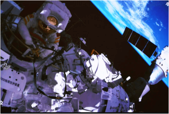 A screen at the Space Control Center in Beijing shows a Chinese astronaut performing extravehicular activities around the space station's Wentian Laboratory module, September 17, 2022.