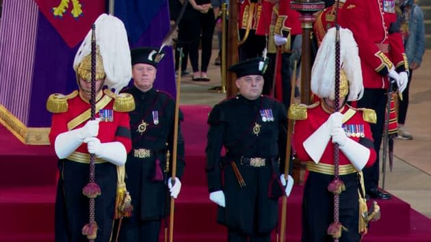 Two British ministers stand guard on the coffin in Westminster Hall