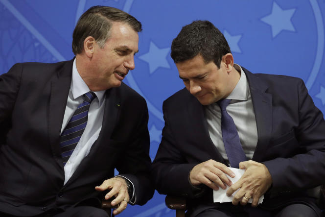 Outgoing Brazilian President Jair Bolsonaro, left, is accompanied by Sergio Moro, right, a former judge who was a member of his cabinet.  June 17, 2019. 