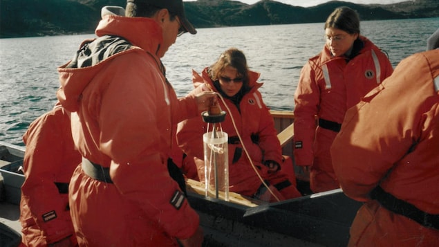 Students take water samples from a boat in Peterhead Inlet, near Iqaluit, September 2003.