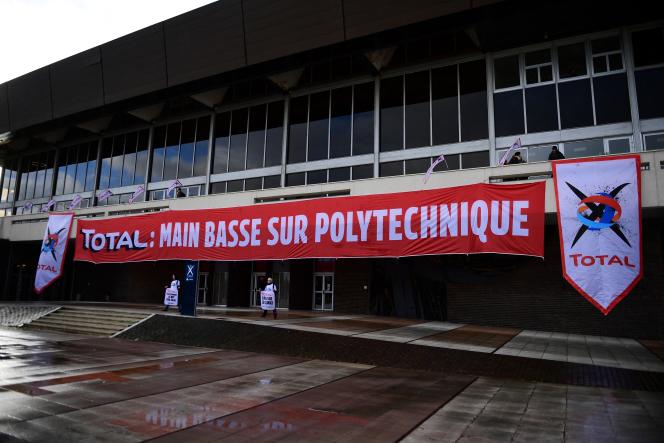 Activists from the environmental group Greenpeace demonstrate in front of the Polytechnic School against the association between oil company Total and l'X, in Palaiseau, March 12, 2020.