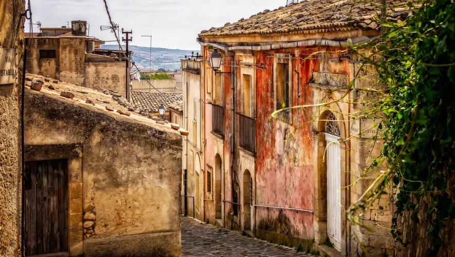 The mayor takes the checkbook and offers €30,000 to whoever will buy an abandoned house in the city centre